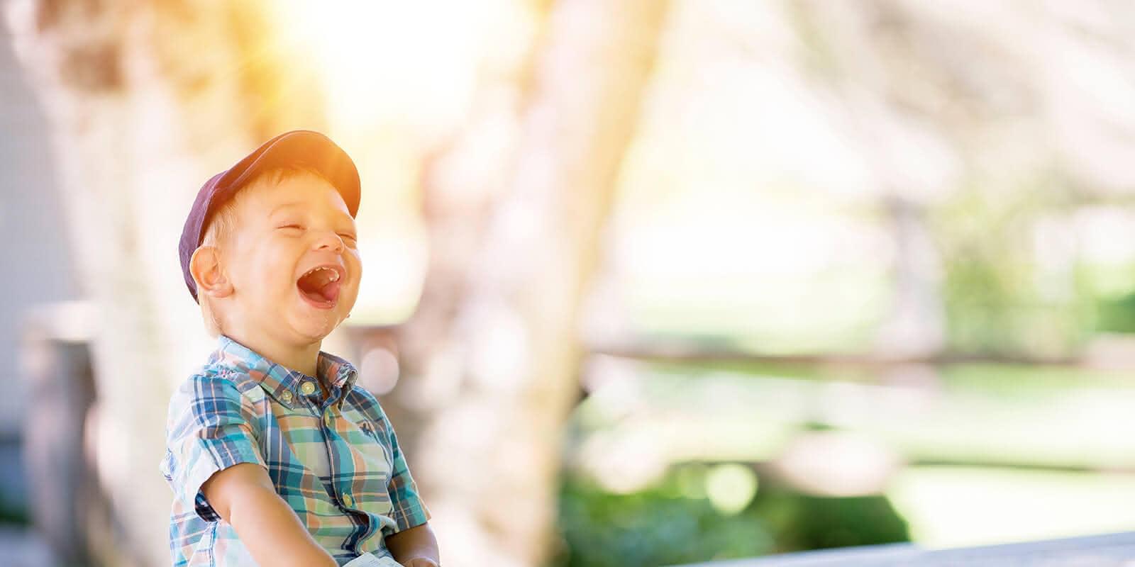 Lachendes Kind mit Buch (c) CC0 1.0 - Public Domain (von unsplash.com) Lachendes Kind mit Buch